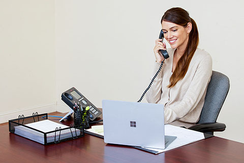 female on the phone at desk