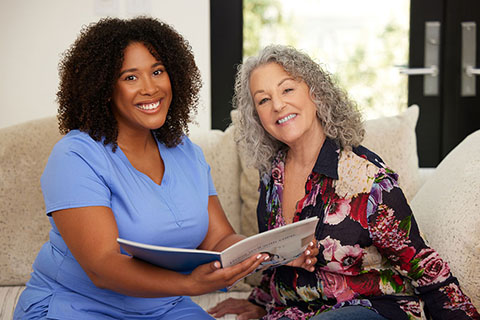 clinical employee with patient reading through a book