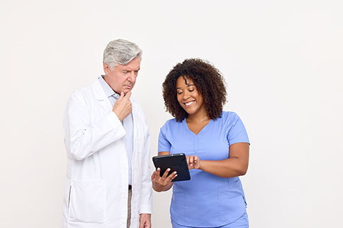 clinicians looking at tablet together