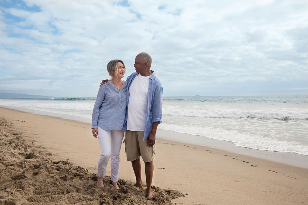 Lifestyle WhiteFemaleBlackMale Beach SmilingatEachOther